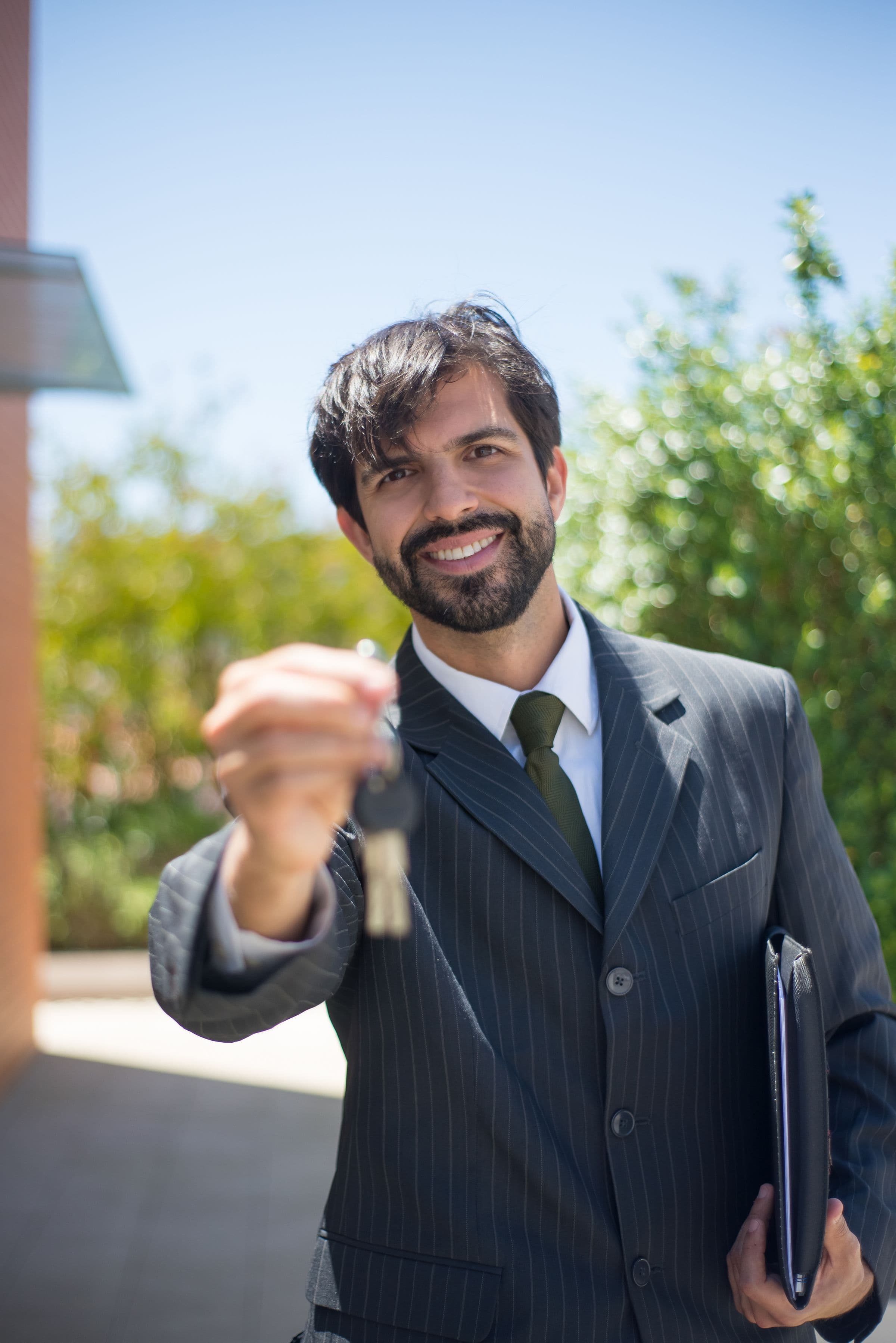 A real estate agent handing over house keys