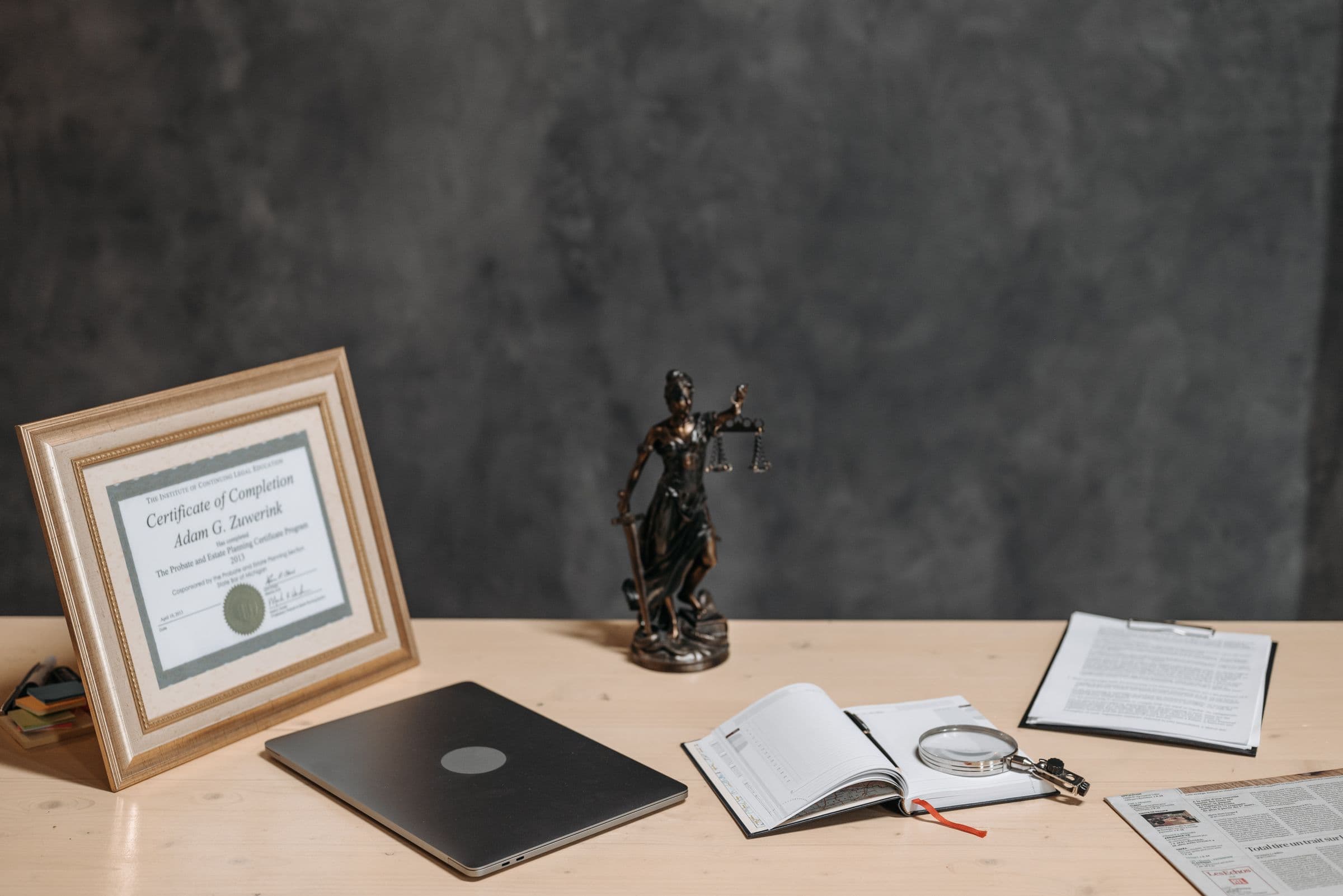Documents and a diploma on a professional's desk